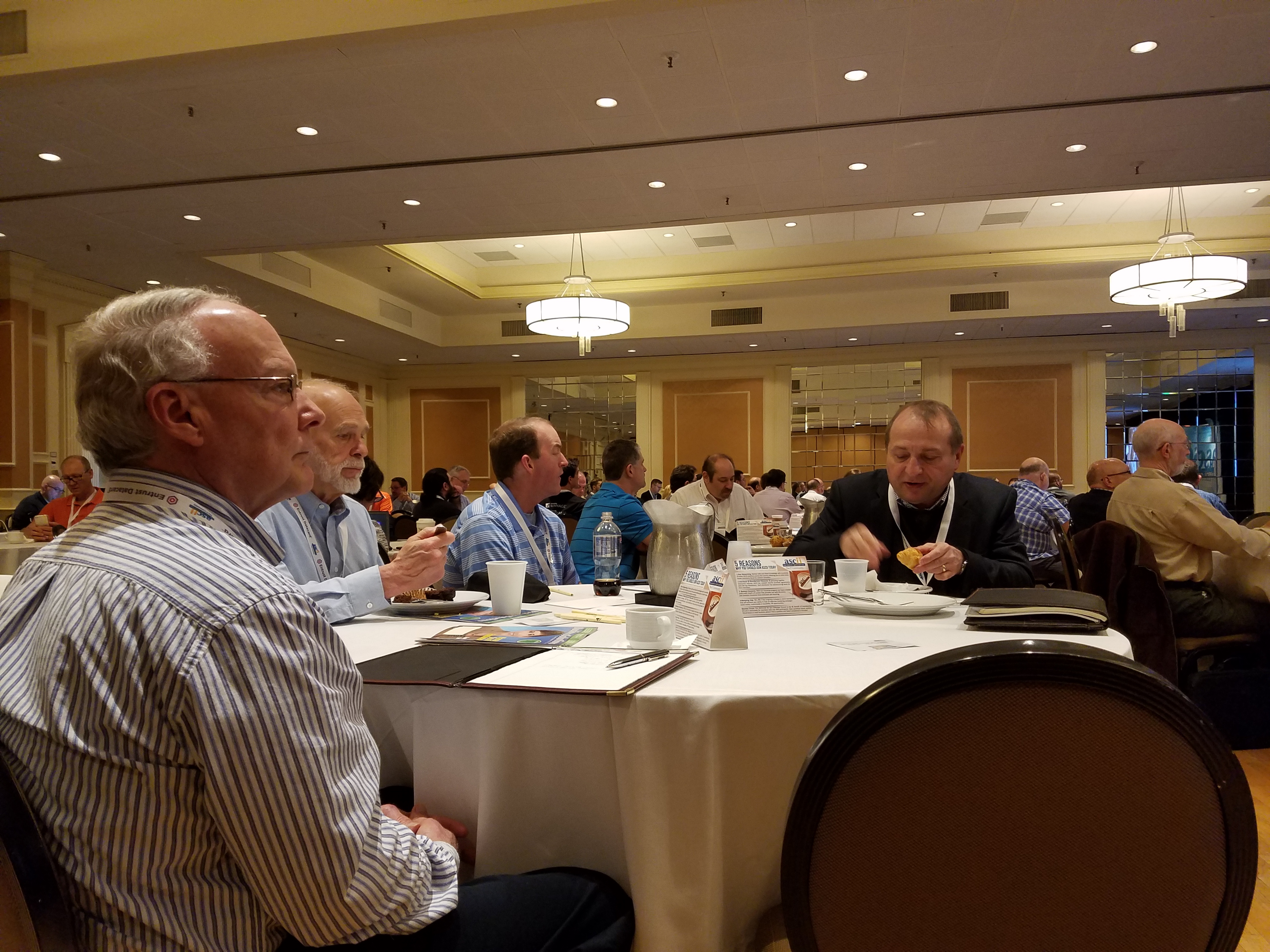People sitting at a table at the ASCII 2017 Bootcamp